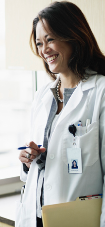 Doctor in discussion with mature female patient in medical exam room